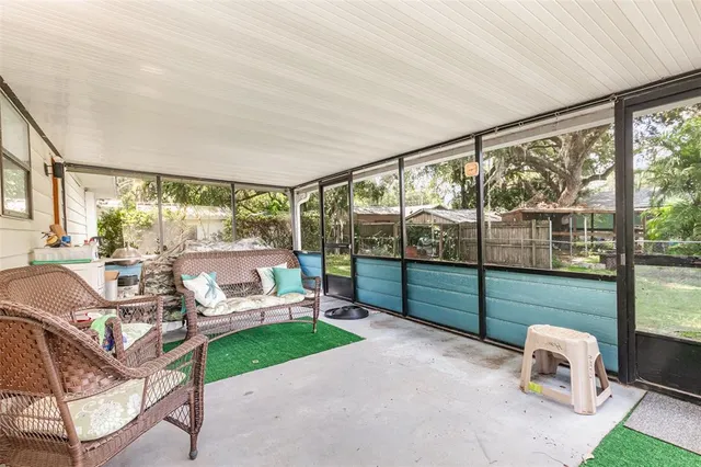 a living room with furniture and a floor to ceiling window