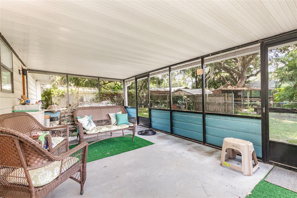 6476 Eve Street St. Cloud, FL 34771 - Photo 21 of 25 a living room with furniture and a floor to ceiling window
