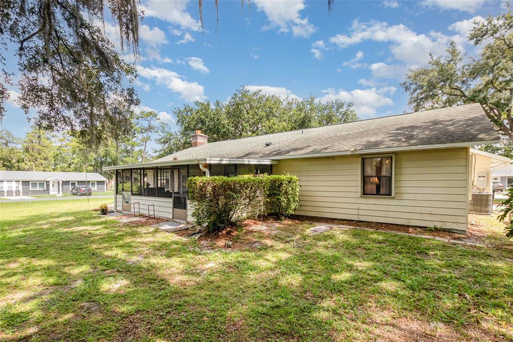 6476 Eve Street St. Cloud, FL 34771 - Photo 22 of 25 a backyard of a house with table and chairs