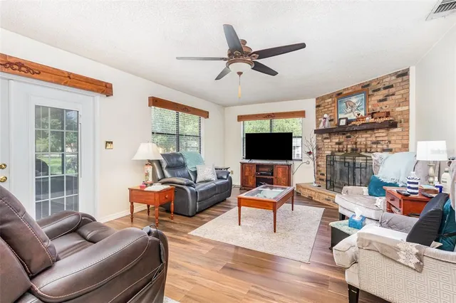 a living room with furniture a flat screen tv and a large window