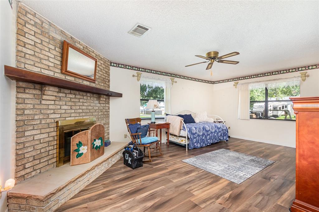 6476 Eve Street St. Cloud, FL 34771 - Photo 6 of 25 a living room with furniture and a fireplace