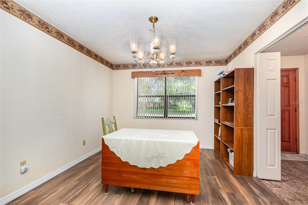 6476 Eve Street St. Cloud, FL 34771 - Photo 7 of 25 a view of a dining room with furniture and a chandelier