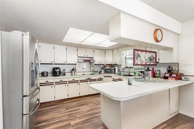 a kitchen with a sink a stove cabinets and refrigerator
