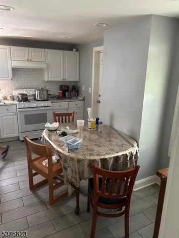 a kitchen with a dining table and chairs