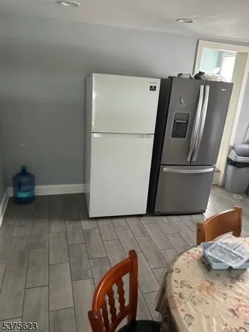 a kitchen with a refrigerator and a stove