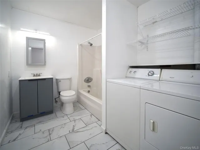 a view of bathroom with a toilet sink and mirror