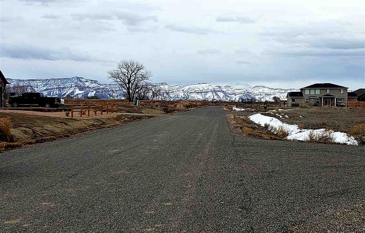 1906 Deer Crossing Road Fruita, CO 81521 - Photo 2 of 4 a view of a lake with a nearby beach