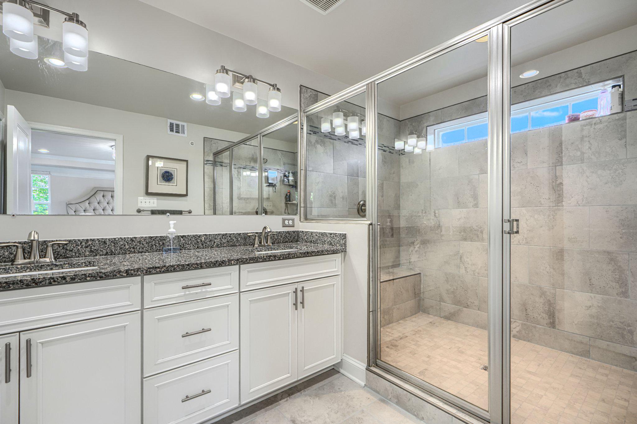 2707 Lady Slipper Road Gambrills, MD 21054 - Photo 38 of 60 a bathroom with a granite countertop sink mirror and shower