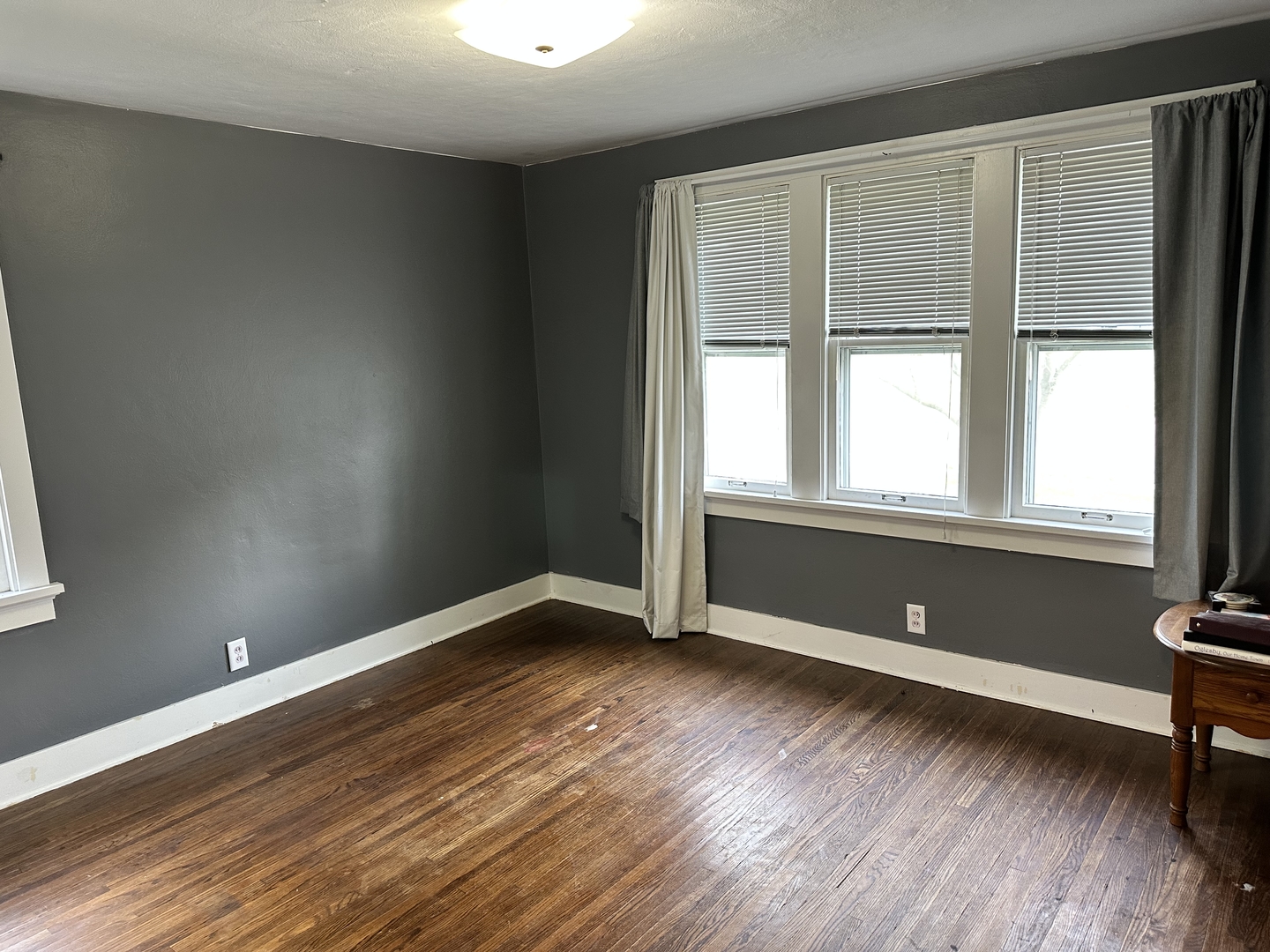 2 Park Road Oglesby, IL 61348 - Photo 6 of 12 an empty room with wooden floor and windows