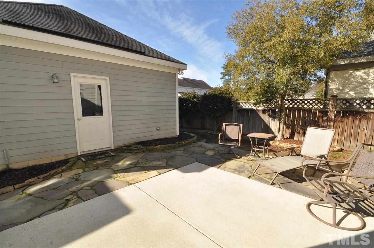 10748 Cokesbury Lane Raleigh, NC 27614 - Photo 14 of 16 a view of a patio with table and chairs with wooden fence and plants