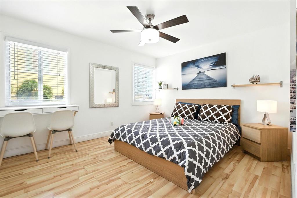 343 Van Buren Street, Unit 8 Hollywood, FL 33019 - Photo 2 of 8 a bedroom with a bed and a table