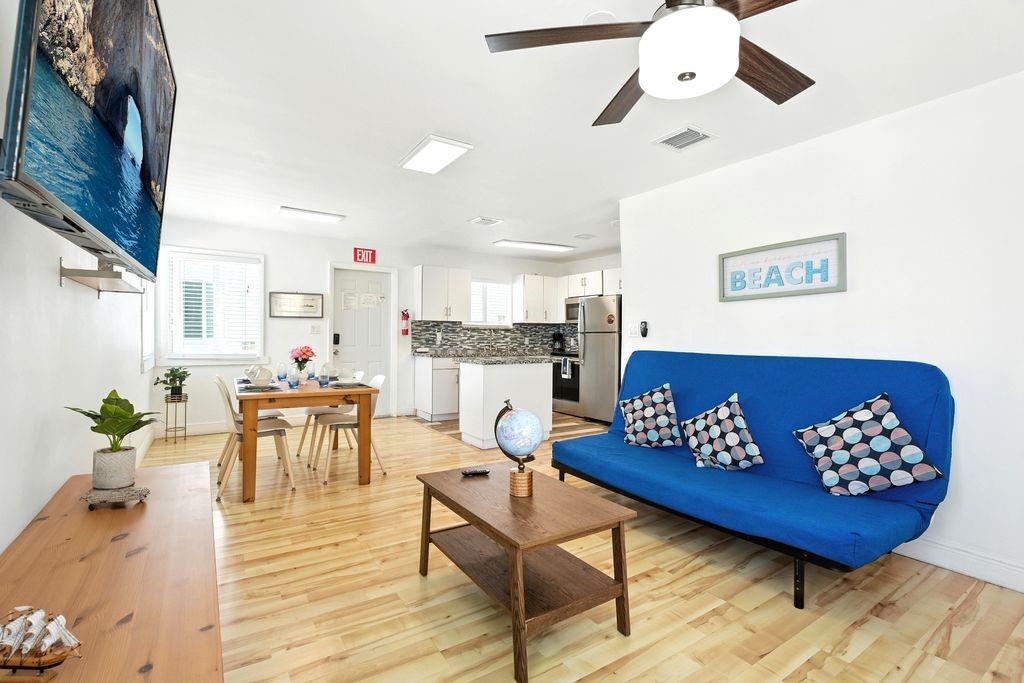 343 Van Buren Street, Unit 8 Hollywood, FL 33019 - Photo 5 of 8 a living room with furniture and wooden floor