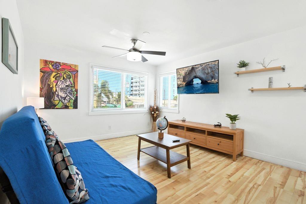 343 Van Buren Street, Unit 8 Hollywood, FL 33019 - Photo 6 of 8 a living room with furniture and a window