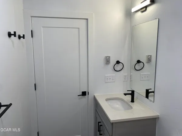 a bathroom with a sink and mirror