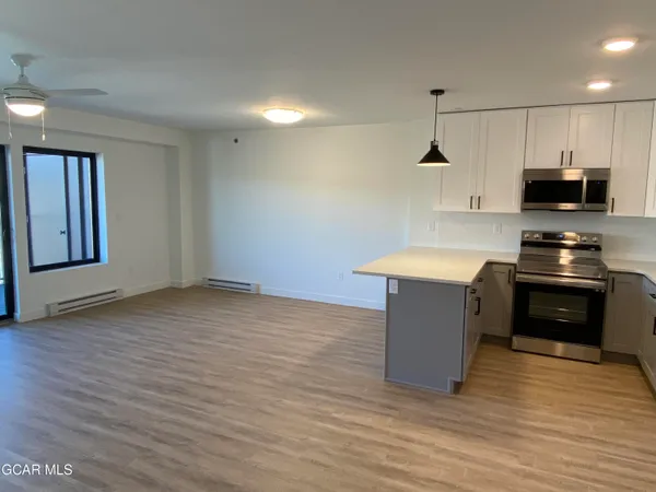 a kitchen with stainless steel appliances granite countertop a sink and a stove