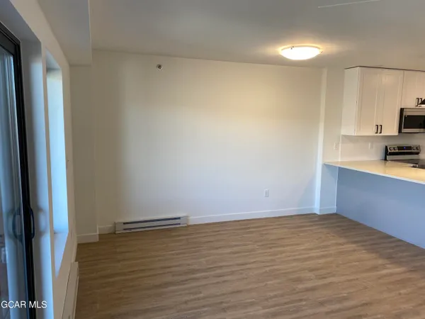 a view of kitchen with wooden floor