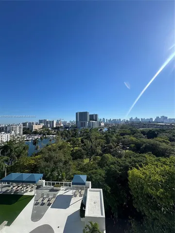 an aerial view of residential house with outdoor space and trees all around