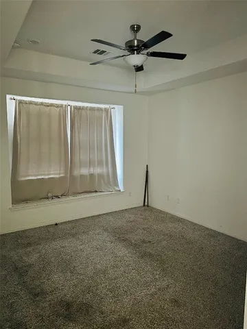 a white toilet sitting next to a window