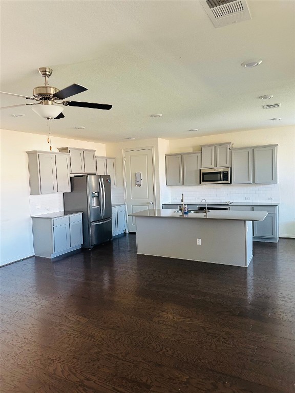 608 Sixpence Lane Georgetown, TX 78628 - Photo 3 of 27 a large kitchen with stainless steel appliances kitchen island granite countertop a stove and a sink