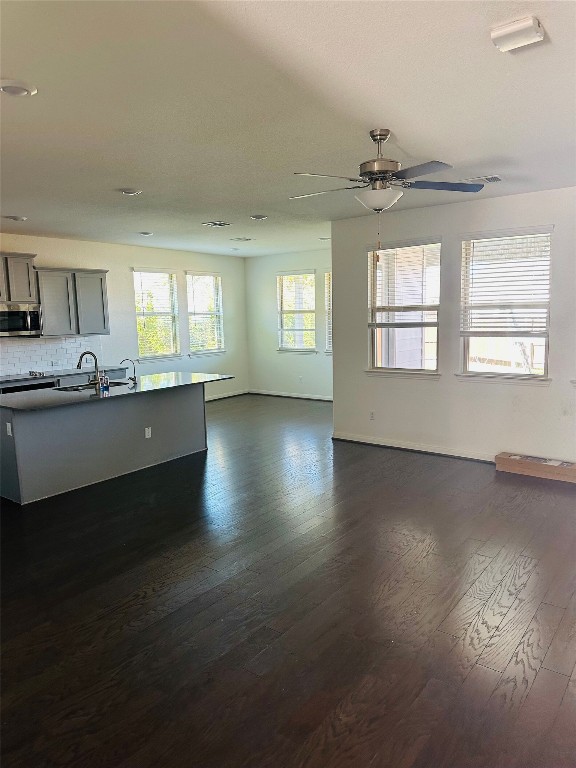 608 Sixpence Lane Georgetown, TX 78628 - Photo 4 of 27 an open kitchen with wooden floor and chandelier
