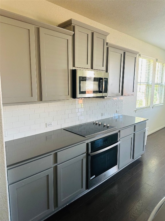 608 Sixpence Lane Georgetown, TX 78628 - Photo 5 of 27 a kitchen with stainless steel appliances a stove microwave and sink