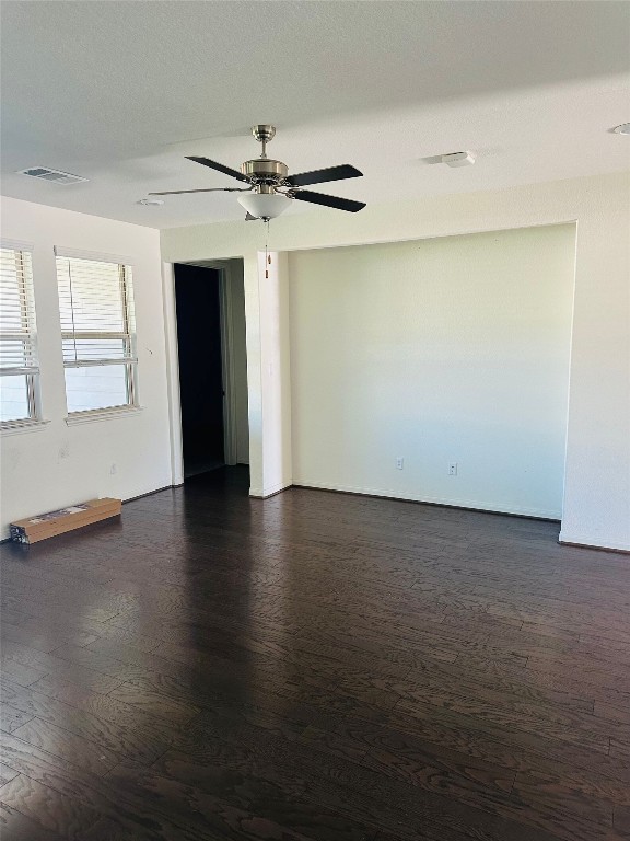 608 Sixpence Lane Georgetown, TX 78628 - Photo 8 of 27 an empty room with wooden floor cabinet and windows