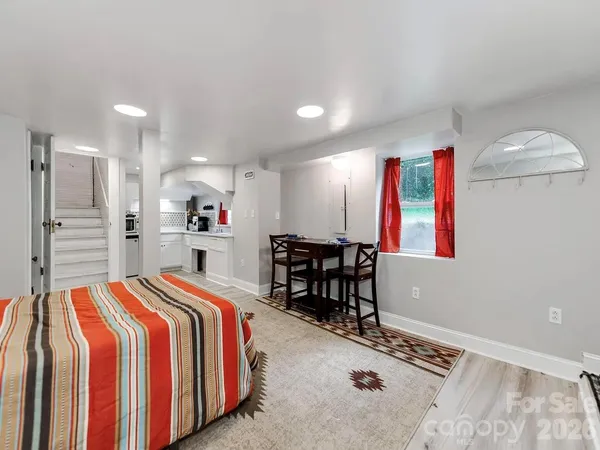 a bedroom with a bed and a table in it