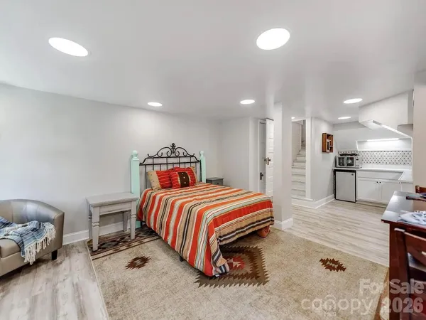 a spacious bedroom with a bed and a couch