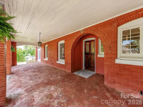 a view of a big room with windows and entryway