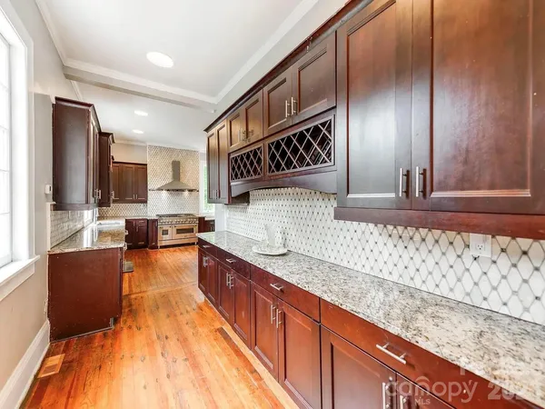 a kitchen with stainless steel appliances kitchen island granite countertop a stove a sink and a microwave