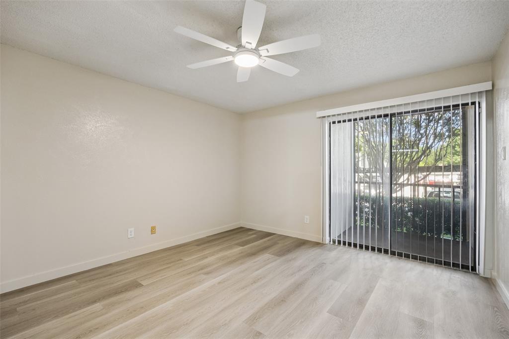 11480 Audelia Road, Unit 136 Dallas, TX 75243 - Photo 11 of 29 Spacious room featuring wood-finish flooring and a ceiling fan