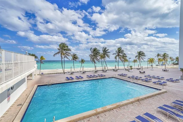 a view of a swimming pool with an outdoor seating