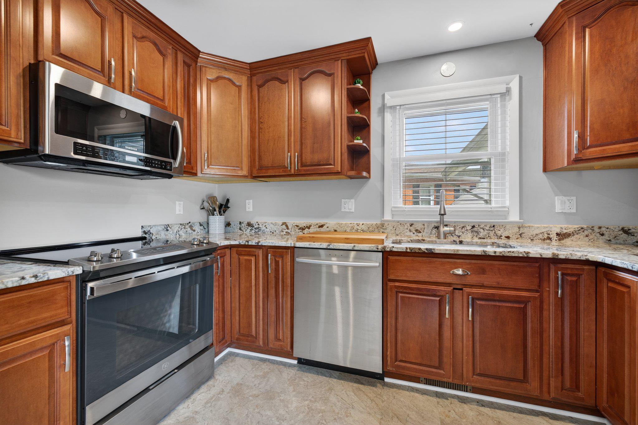 1002 Wilson Place Frederick, MD 21702 - Photo 6 of 30 a kitchen with stainless steel appliances granite countertop a stove microwave and sink