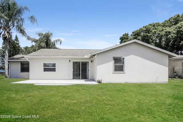 a house that has a big yard and large trees