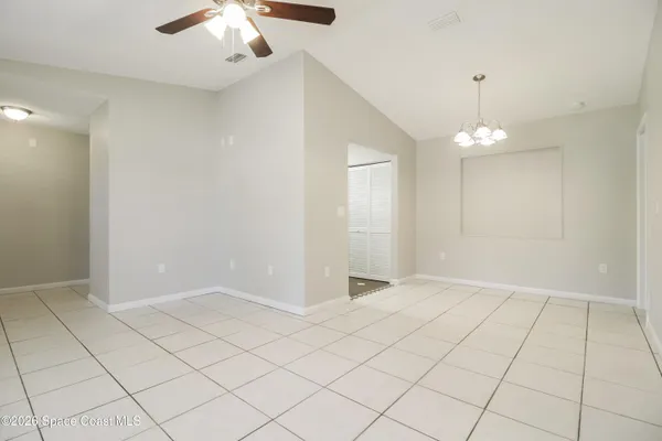 an empty room with kitchen view