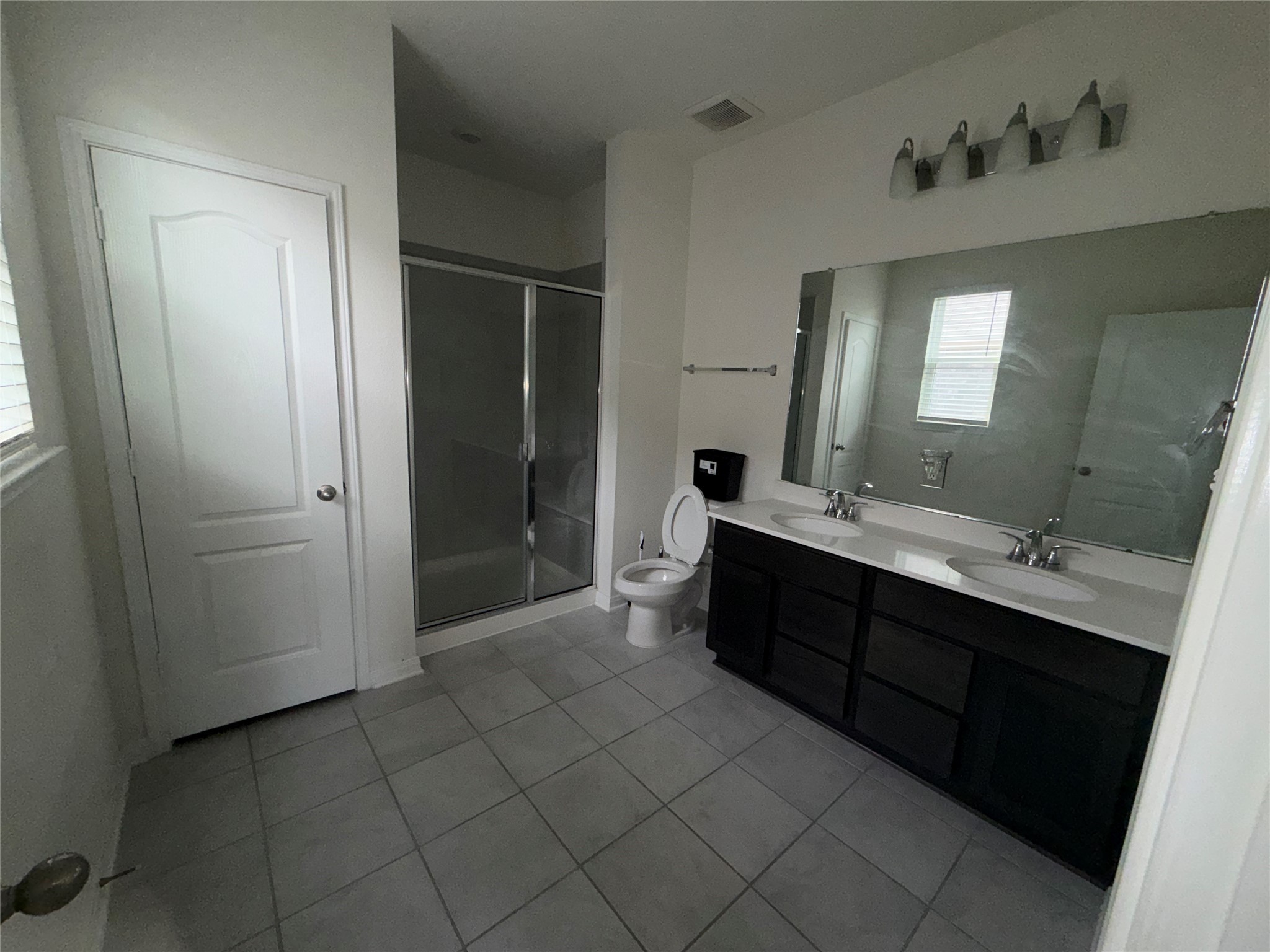 14622 Cypress Creek Landing Houston, TX 77068 - Photo 15 of 33 a spacious bathroom with a double vanity sink toilet and mirror