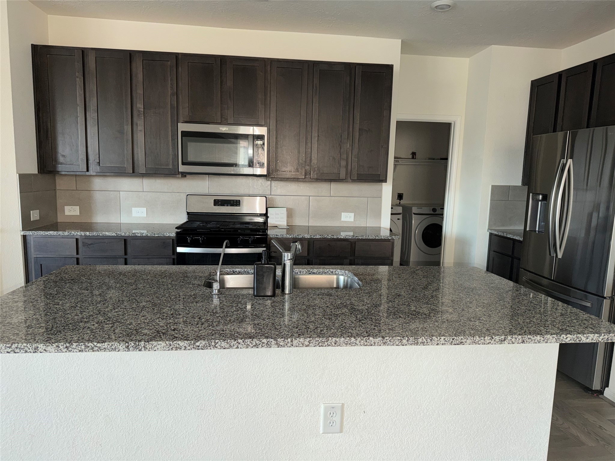 14622 Cypress Creek Landing Houston, TX 77068 - Photo 21 of 33 a kitchen with a refrigerator a microwave a sink and cabinets