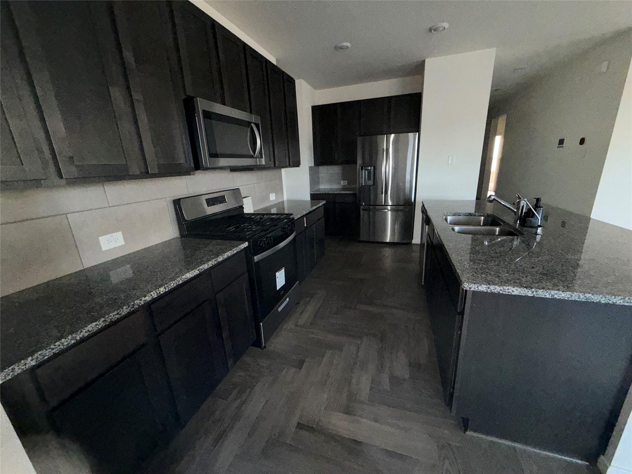 14622 Cypress Creek Landing Houston, TX 77068 - Photo 23 of 33 a kitchen with granite countertop stainless steel appliances a stove sink and microwave