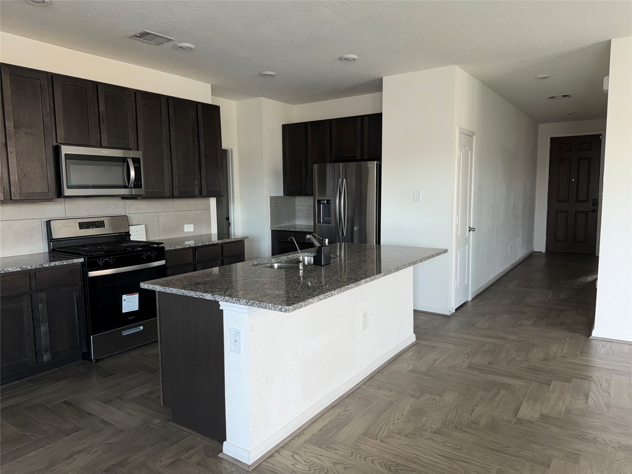 14622 Cypress Creek Landing Houston, TX 77068 - Photo 25 of 33 a kitchen with kitchen island granite countertop stainless steel appliances a sink a stove a refrigerator cabinets and a counter top space