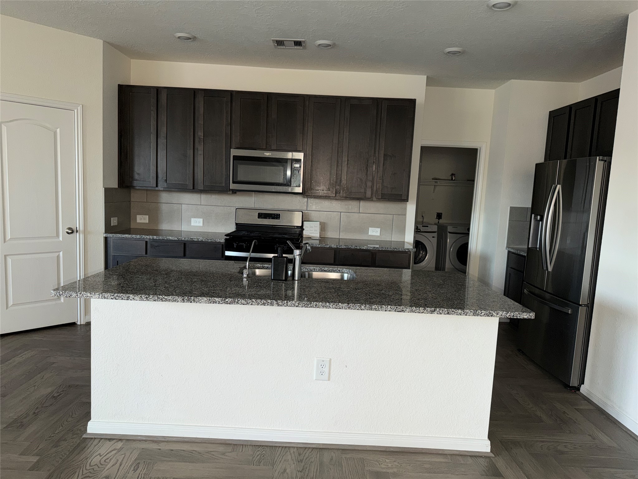 14622 Cypress Creek Landing Houston, TX 77068 - Photo 26 of 33 a kitchen with stainless steel appliances granite countertop a refrigerator a sink a stove a microwave and wooden cabinets