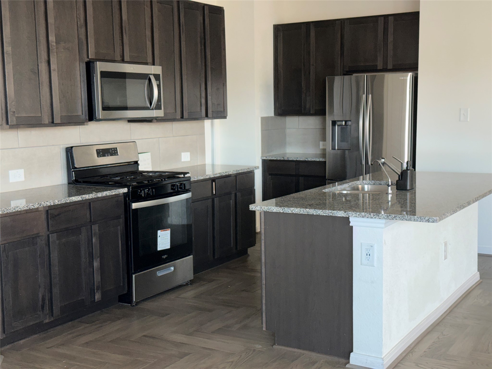 14622 Cypress Creek Landing Houston, TX 77068 - Photo 5 of 33 a kitchen with stainless steel appliances wooden cabinets and a stove top oven