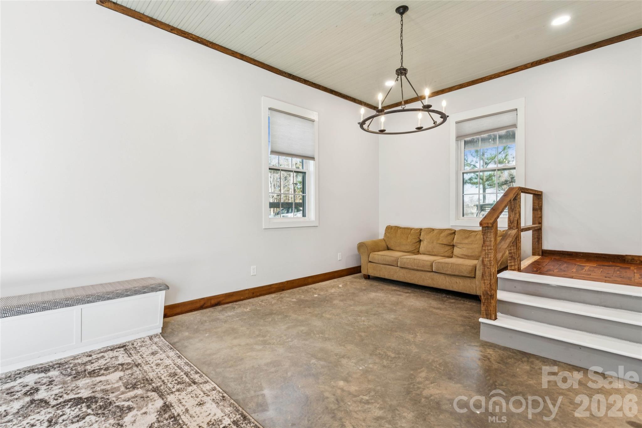 10799 Poplar Tent Road Huntersville, NC 28078 - Photo 11 of 46 a living room with furniture and a chandelier