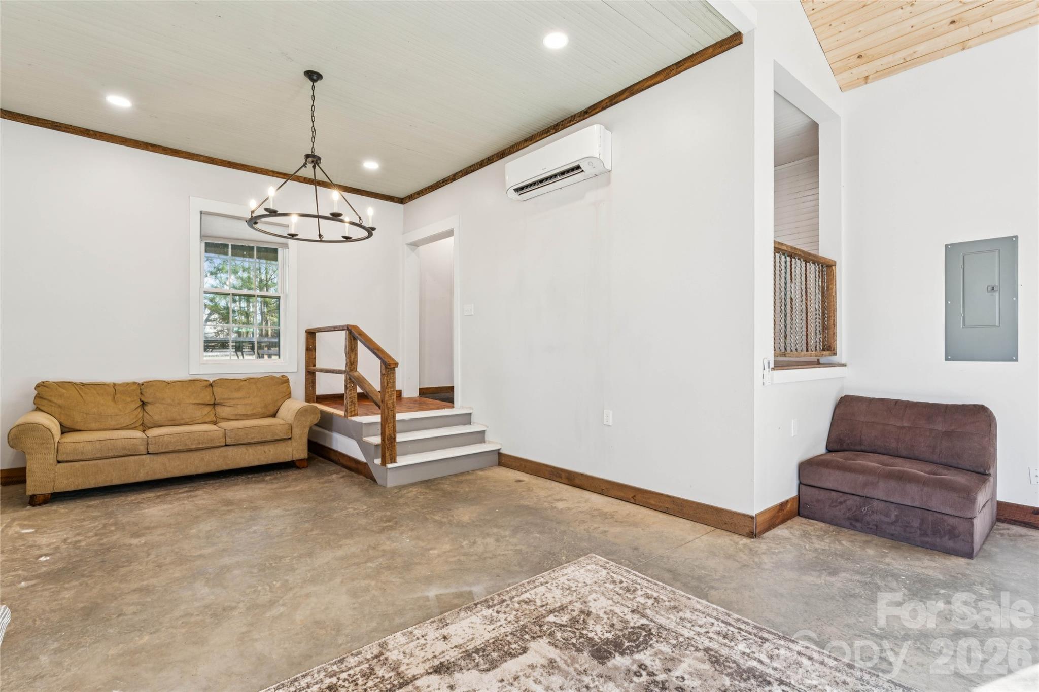 10799 Poplar Tent Road Huntersville, NC 28078 - Photo 12 of 46 a living room with furniture and a chandelier