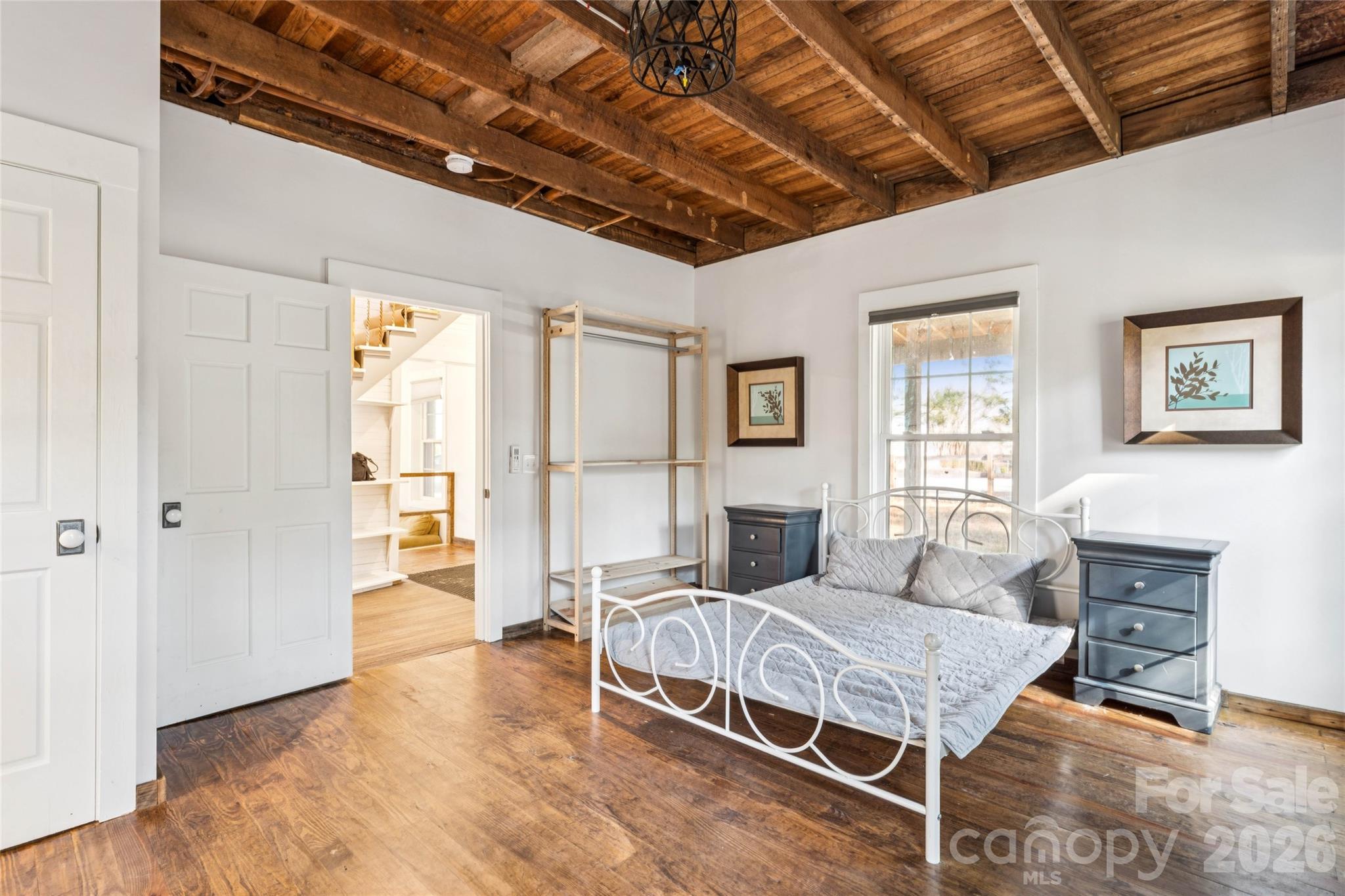 10799 Poplar Tent Road Huntersville, NC 28078 - Photo 23 of 46 a bedroom with a bed a table and chair with the outer view