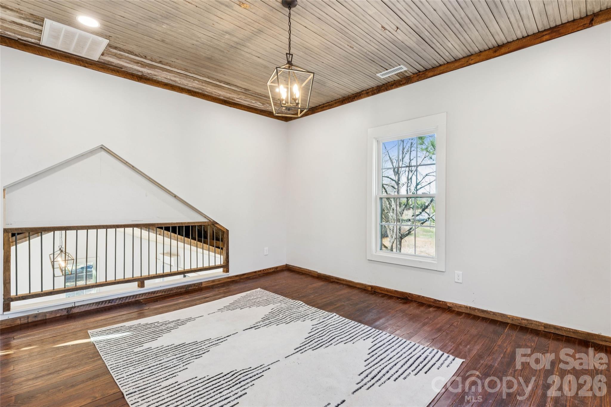 10799 Poplar Tent Road Huntersville, NC 28078 - Photo 27 of 46 a view of a room with wooden floor windows and a ceiling fan