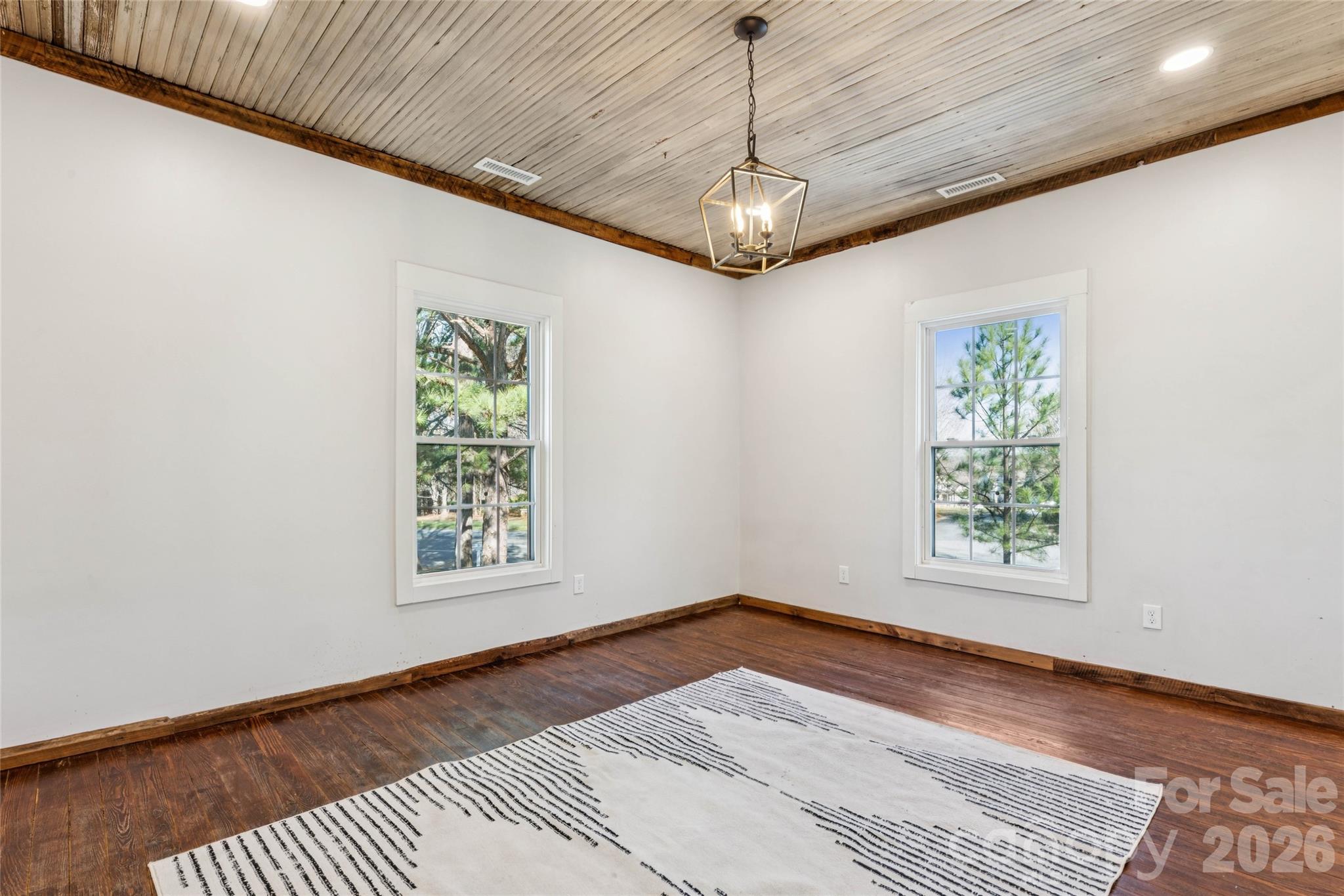 10799 Poplar Tent Road Huntersville, NC 28078 - Photo 30 of 46 a view of a big room with windows chandelier fan and windows