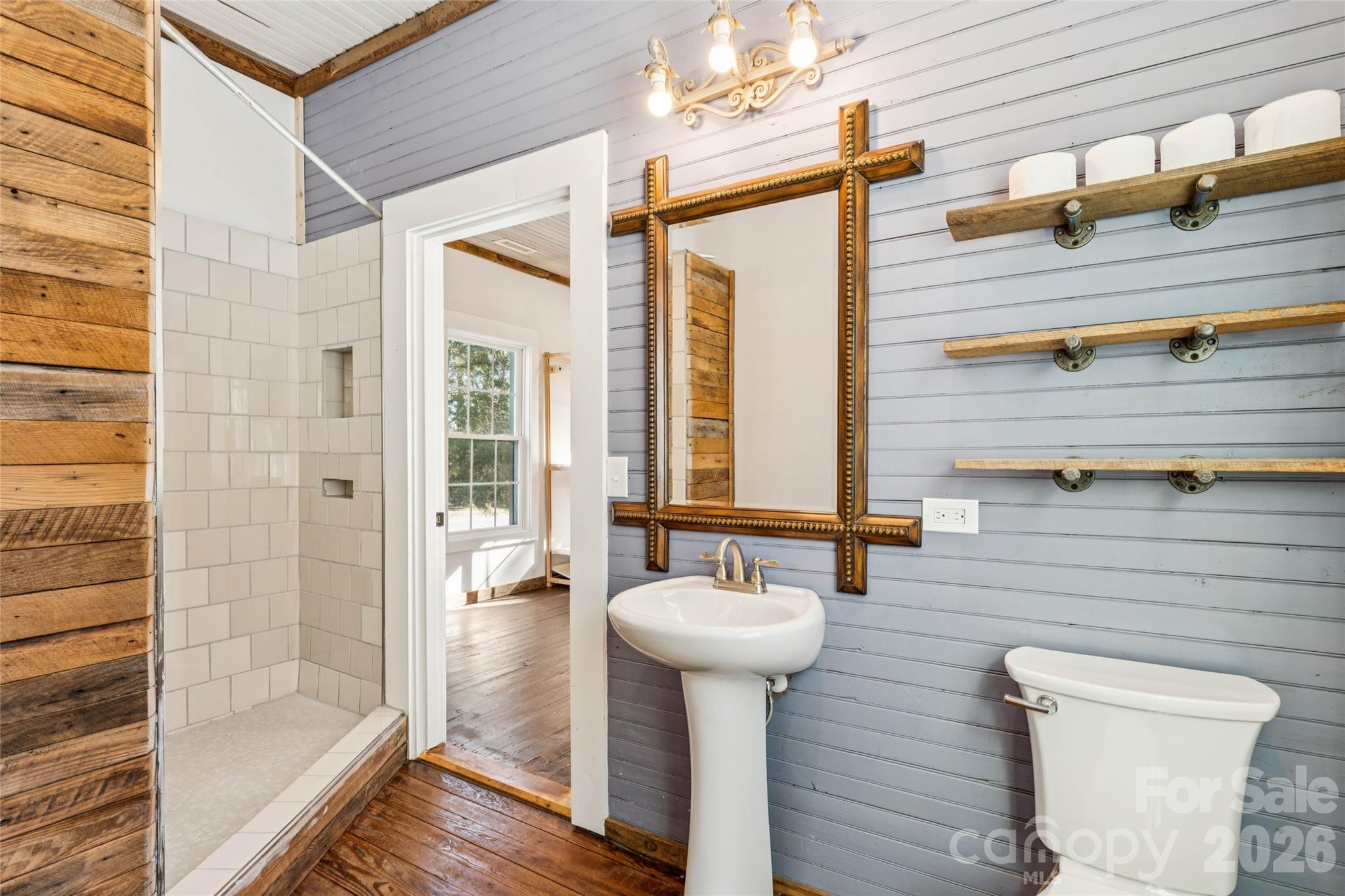 10799 Poplar Tent Road Huntersville, NC 28078 - Photo 31 of 46 a bathroom with a sink a mirror and shower