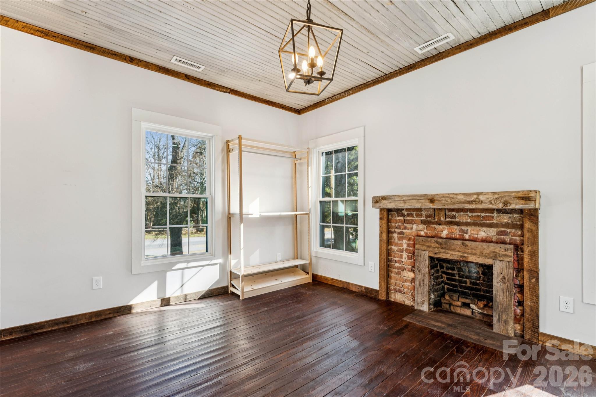 10799 Poplar Tent Road Huntersville, NC 28078 - Photo 36 of 46 a view of an empty room with wooden floor fireplace and a window