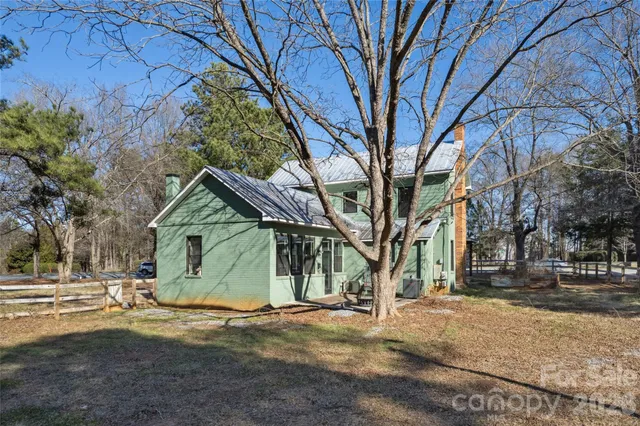 a view of a house with a yard covered in snow