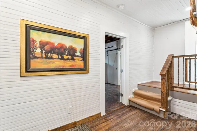 a view of front door with wooden floor and a rug